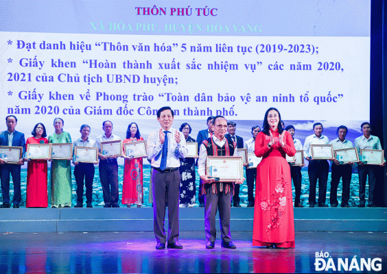 Trưởng  thôn Phú Túc Lê Văn Nghĩa (giữa) nhận danh hiệu “Thôn văn hóa” tiêu biểu cấp thành phố 2024. Ảnh: NGỌC PHÚ