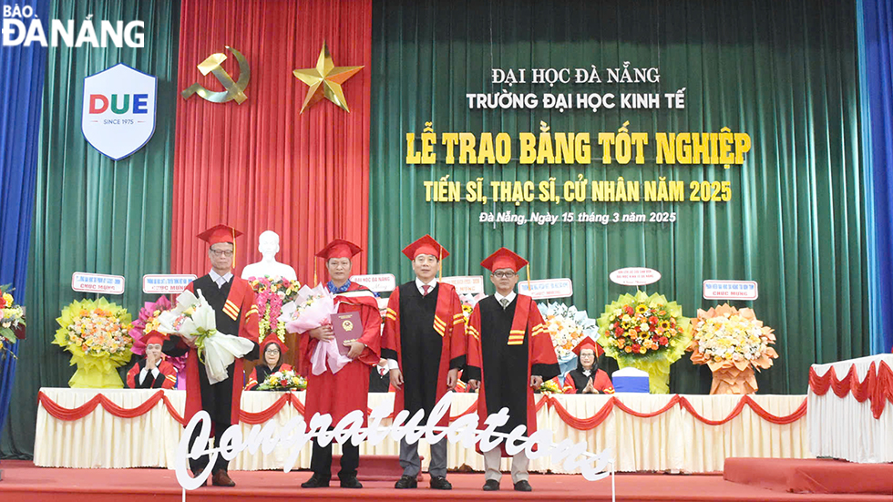 Đại diện lãnh đạo nhà trường trao bằng cho các tân Tiến sĩ. Ảnh: THU HÀ